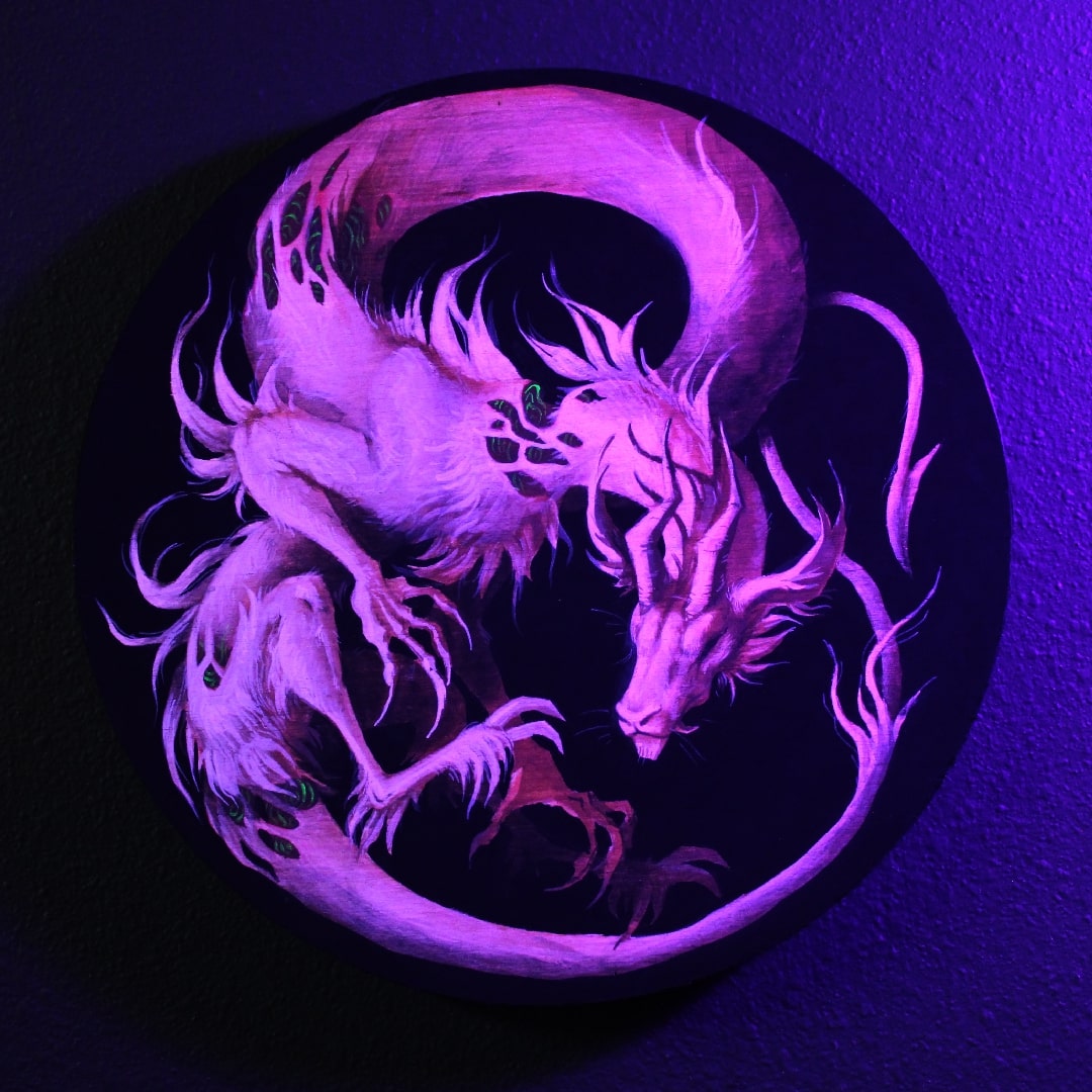 Same painting of the dragon, but up close and glowing under uv light.